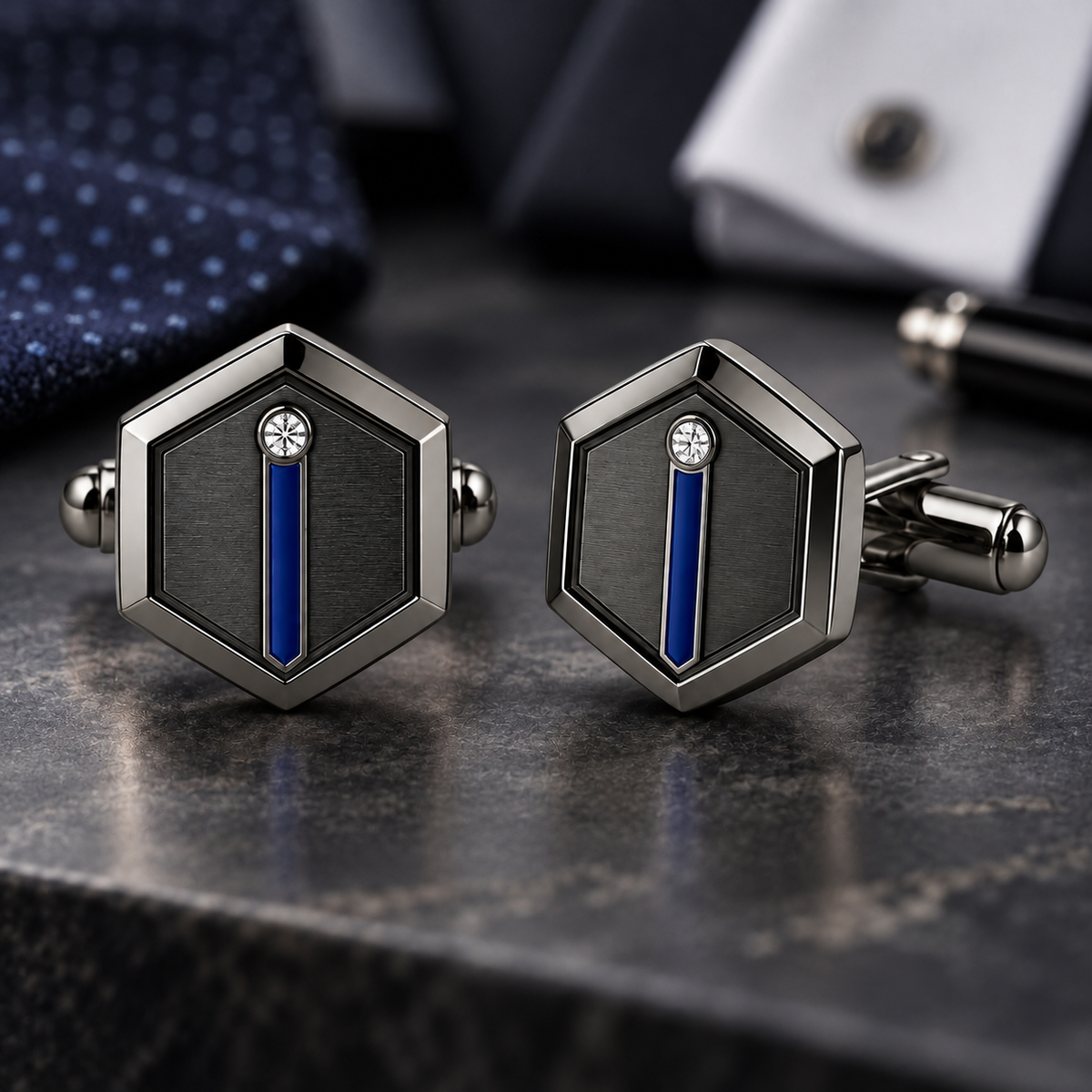 Pair of black hexagonal cufflinks with silver-tone borders, narrow blue stripes, and small clear stones