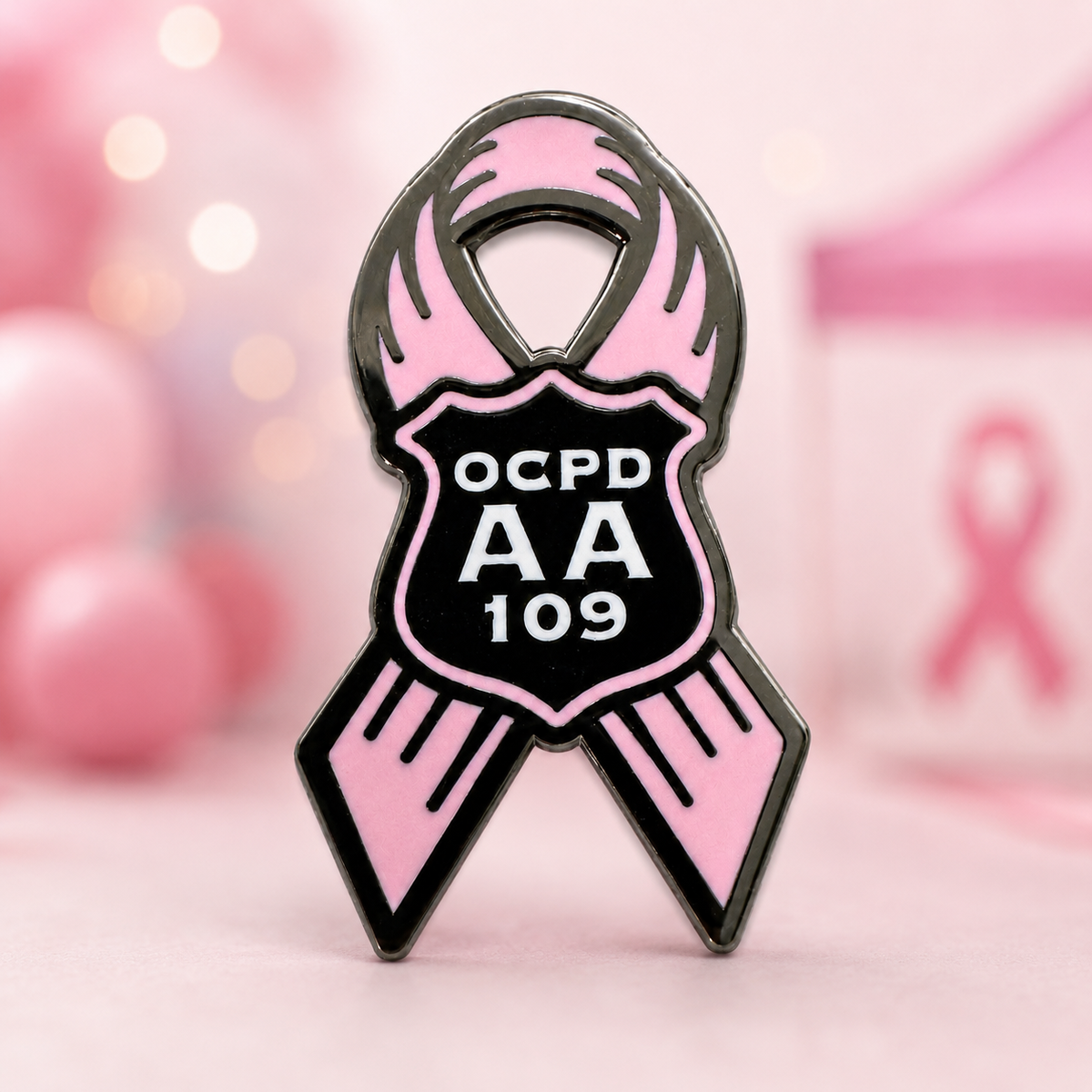 Pink and black hard enamel awareness ribbon pin with an OCPD AA 109 police shield