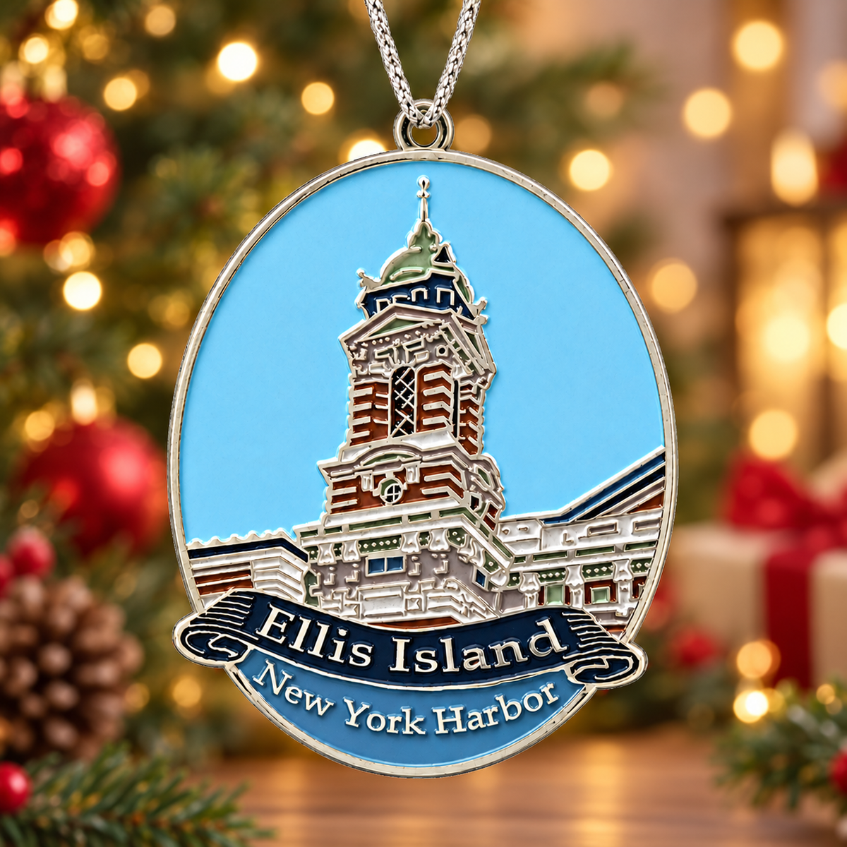 Oval Ellis Island ornament showing the historic building against a blue sky with a silver-tone hanging cord