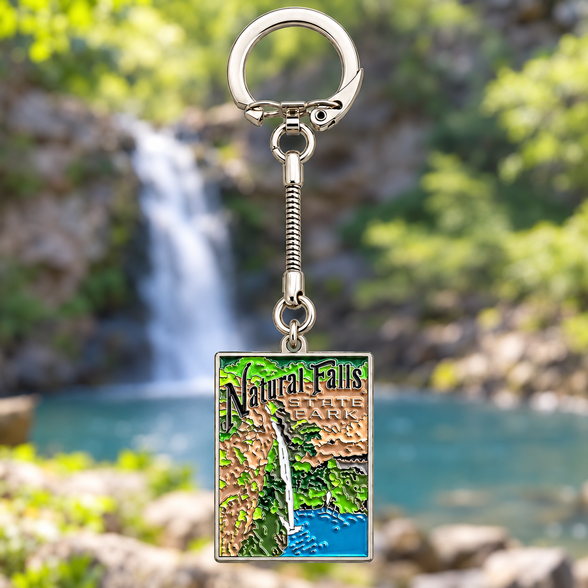 Rectangular Natural Falls State Park keychain showing a waterfall and greenery, attached to a silver-tone split ring
