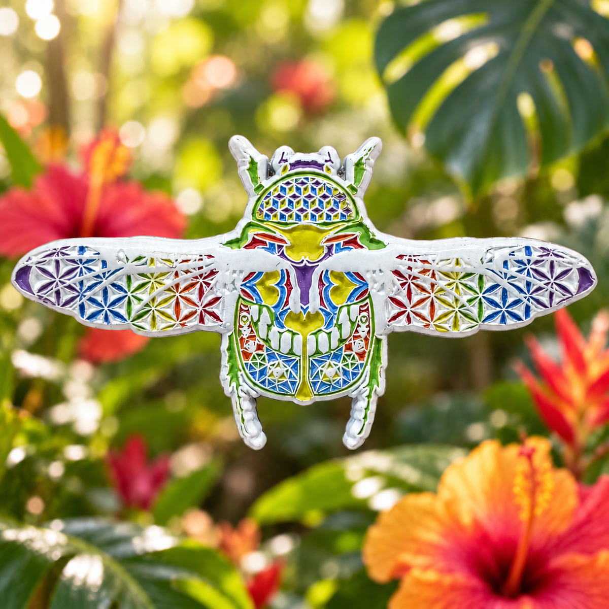 A winged beetle combines rainbow enamel with intricate white geometric patterns