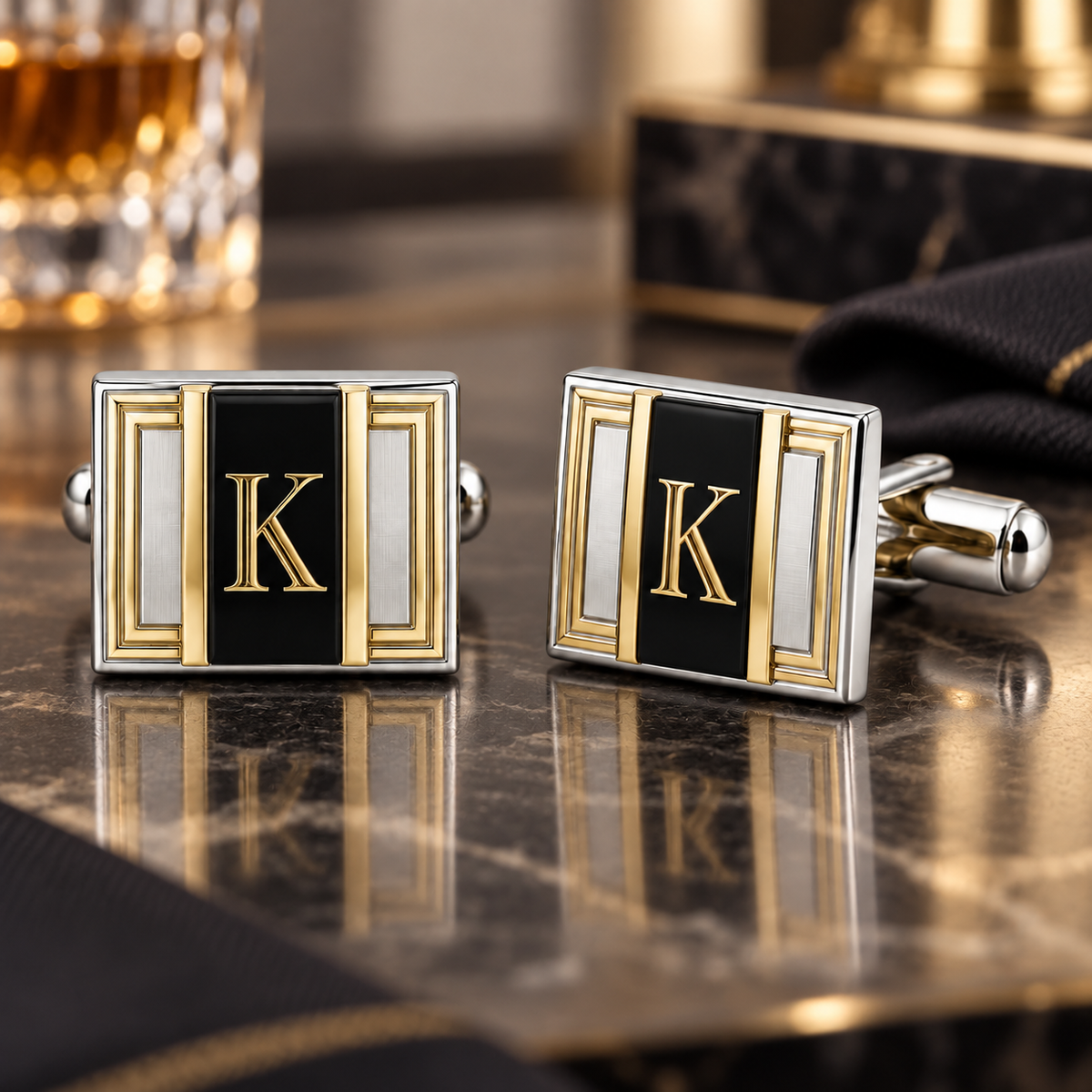 Pair of rectangular two-tone cufflinks with gold letter K monograms on black center panels