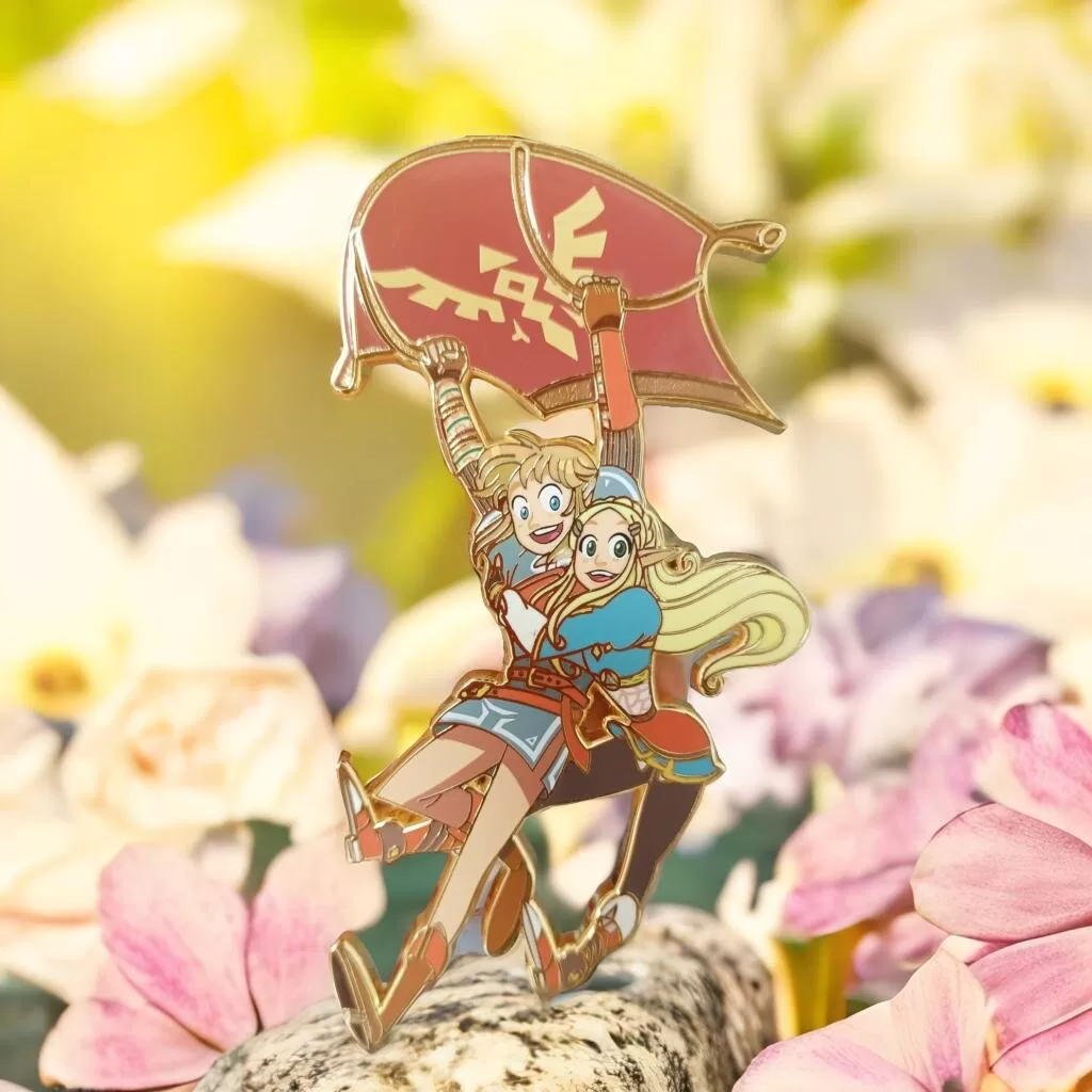 A vibrant enamel pin featuring an adventurous duo soaring with a paraglider amidst a floral background.