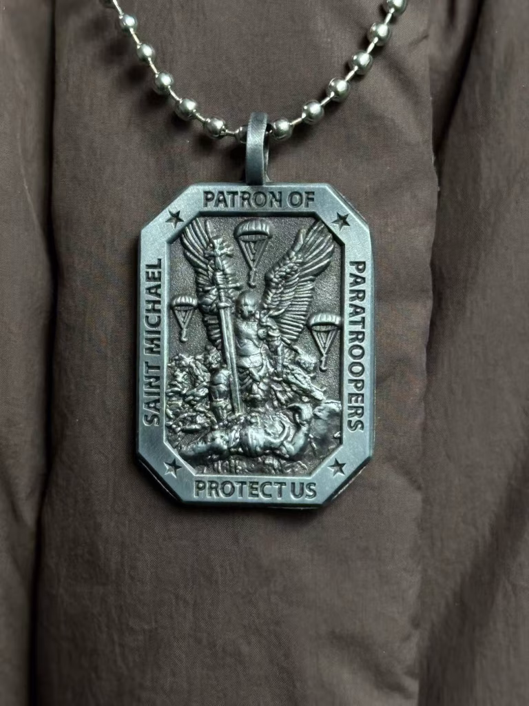 Custom St. Michael Medallion displayed on clothing, highlighting intricate 3D relief and antique silver pendant design