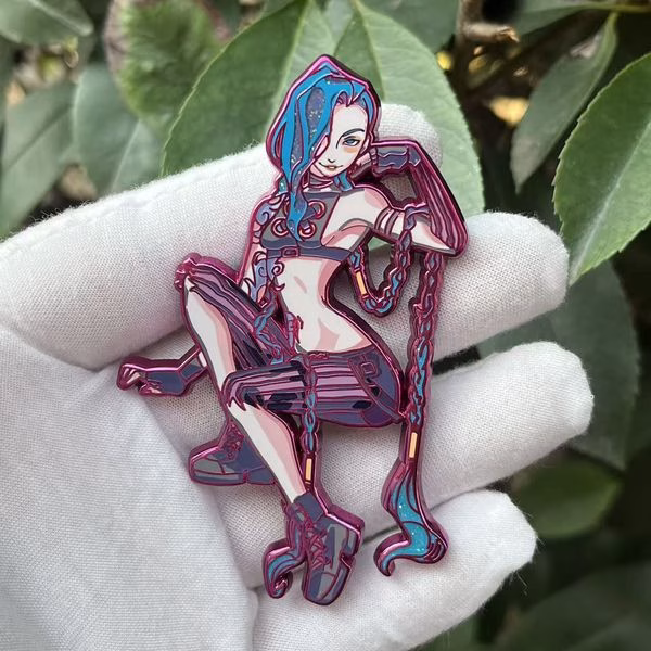 Smirk Jinx hard enamel lapel pin with pink chrome, smooth polished surface, internal cut-out details, gradient printed colors, and dual rubber clutches.