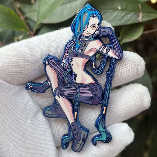Smirk Jinx hard enamel lapel pin with blue chrome, smooth polished surface, internal cut-out details, gradient printed colors, and dual rubber clutches.
